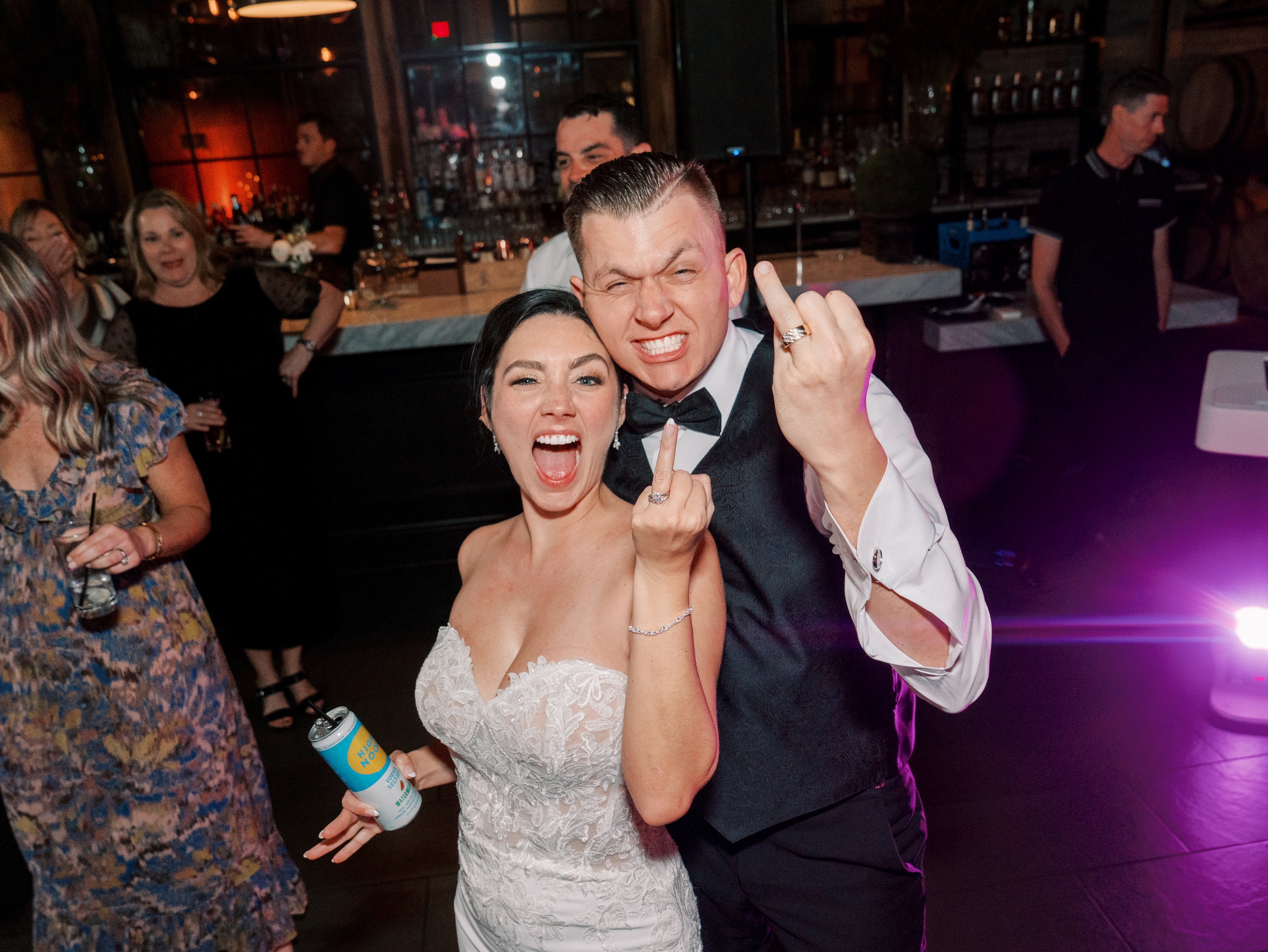 Bride and groom celebrating on the dance floor with guests at a Modern Era Weddings reception